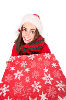 Happy and beautiful girl with freckles in Christmas holding a present