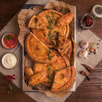 Different pies from meat and vegetables. Freshly baked cakes on a table