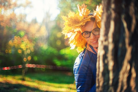 Beauty woman at autumn park in sunny beauty day