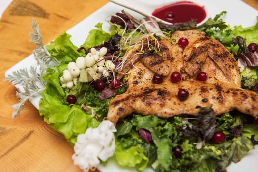 quail roasted with sweet and sour cranberry sauce decorated with rowanberry