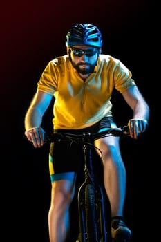 The male bicyclist on black, studio shot.