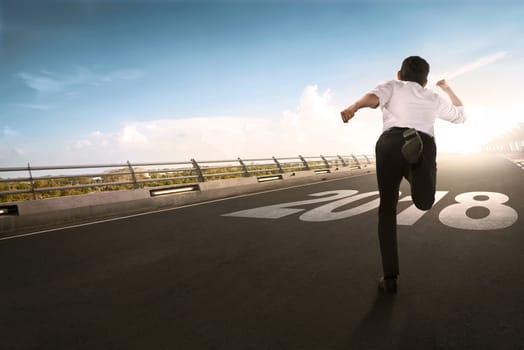 Back view of asian businessman running. Happy New Year 2018