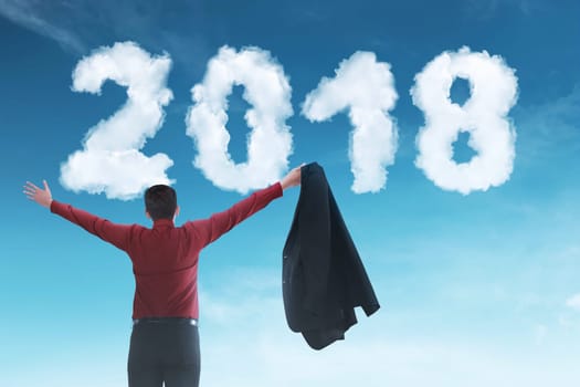 Back view of asian businessman looking blue sky. Happy New Year 2018