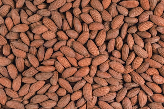 Scattered almonds on a flat background.