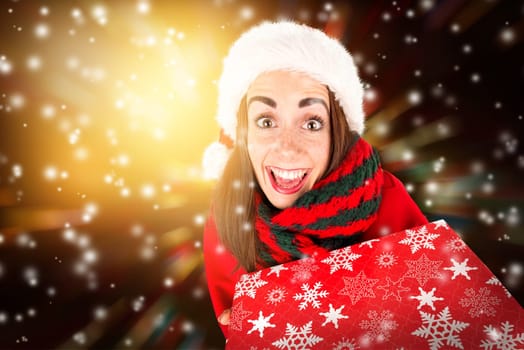 Happy and beautiful girl with freckles in Christmas holding a present