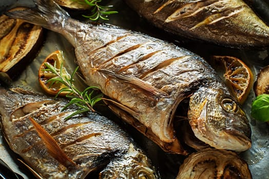 Grilled Gilt-head bream fish with lemon herbs oil vegetables and spices