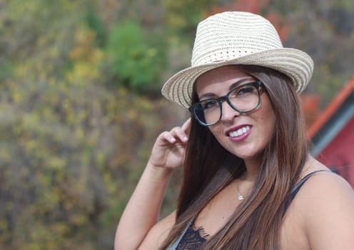 young women wearing straw hat and glasses outdoor portrait in sunshine