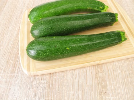 Green zucchini on a cutting board
