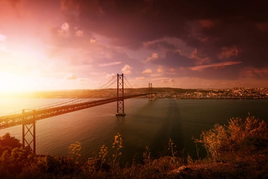 "25 de Abril"" bridge in Lisbon Portugal at sunset"