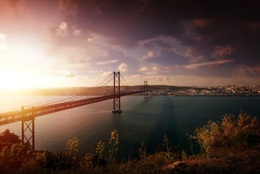 "25 de Abril"" bridge in Lisbon Portugal at sunset"