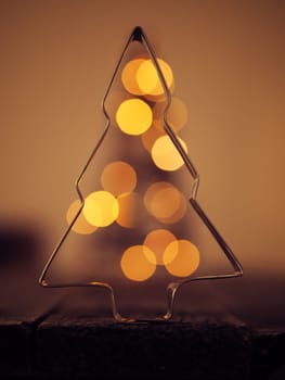 Christmas background with a tree shape and blurred lights, romantic color style with soft bokeh
