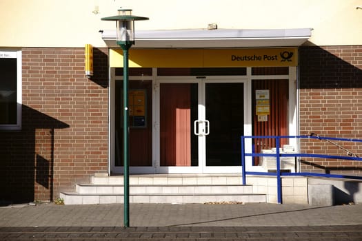 Griesheim,Germany - October 31,2017: The entrance of a Deutsche Post branch with a disabled driveway and a lantern on October 31,2017 in Griesheim.