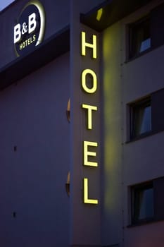 Darmstadt,Germany - October 31,2017: The façade of a neon-lit B and B hotel with neon tubes above the entrance on October 31,2017 in Darmstadt.