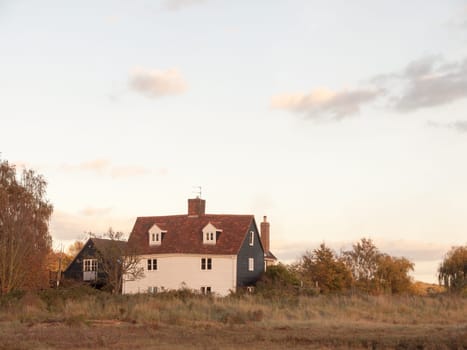 old white country farm house cottage in field  essex  england  uk