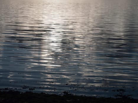 beautiful water surface sunset light waves ripples light  essex  england  uk