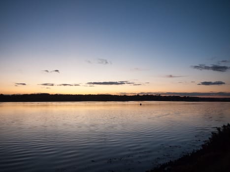 beautiful sunset evening bay scene open space water surface waves  essex  england  uk