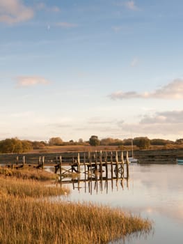 harbour pier dock wooden structure water outside boats lake river day  essex  england  uk