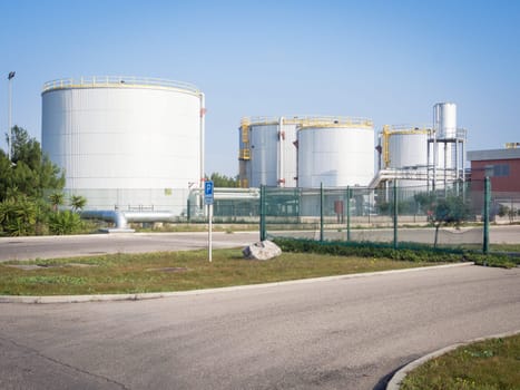 white industrial tanks in the industrial port of Oristano