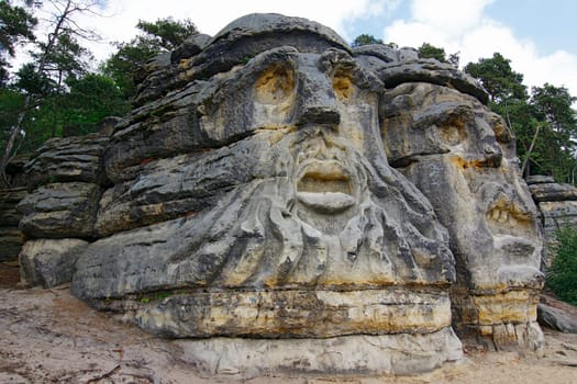 Heads of Devils are about 9 m high rock sculptures of giant heads carved into the sandstone cliffs in the pine forest above the village Zelizy in the district Melnik, Czech republic. It is the work of sculptor Vaclav Levy, who created in the period 1841-1846.