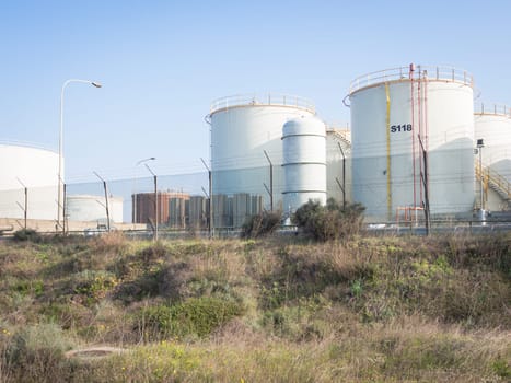 white industrial tanks in the industrial port of Oristano