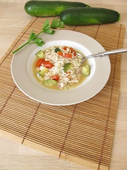 Homemade chicken soup with zucchini and tomatoes