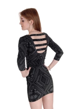 A young beautiful woman in a gray short dress standing from the back.looking down with nice jewellery, isolated for white background.