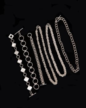 A nice display of handmade silver jewellery on a black beard.