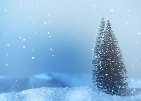 Winter landscape with two trees colored in cold blue with space for text or image