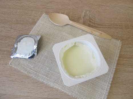 Yoghurt in a plastic cup with aluminium lid