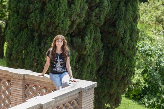 Nice girl over a squared balcony in Italy