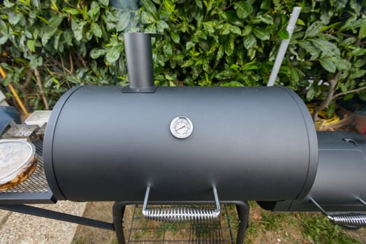 A black barbecue ready for grilling a slow cook pulled pork and ribs