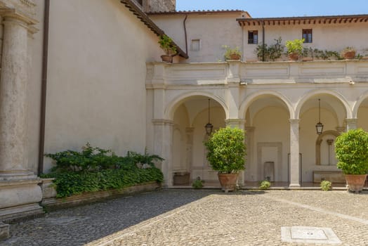 A beautiful building with arches in a public square in Tivoli, Italy