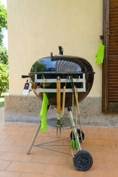 A closed barbecue during pulled pork cooking day, with tools