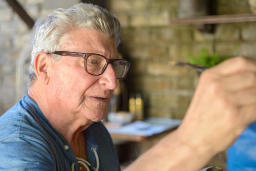Senior Man painting a picture with oil colors