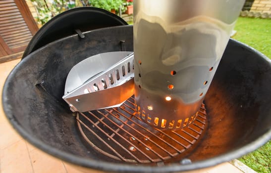 preparing briquette and barbecue for grilling meat