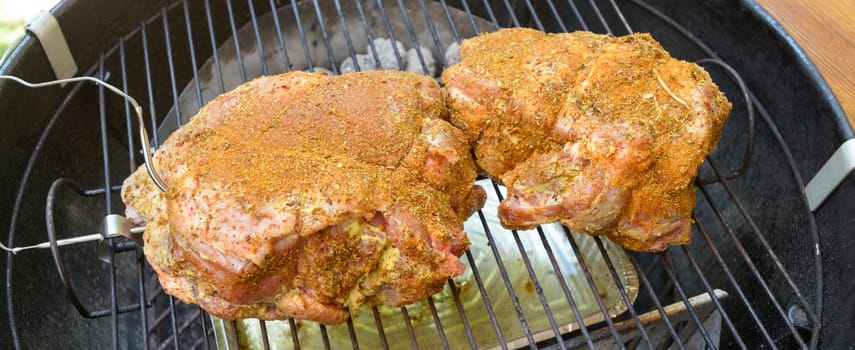Pulled pork cooking and grilling inside a barbecue