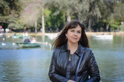 A nice girl posing near a beautiful lake in Rome, Italy
