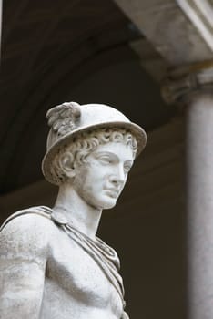 Vatican, Italy - October 31, 2015:  Hermes Ingenui Hermes wears his usual attributes: kerykeion (or herald's staff), kithara, petasus (round hat), traveller's cloak and winged temples. Marble, Roman copy of the 2nd century BC after a Greek original of the 5th century BC.