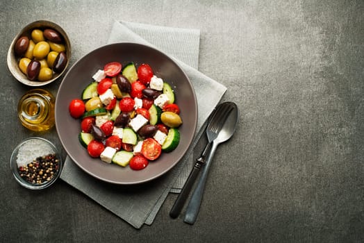 Salad with cheese and fresh vegetables on gray background. Greek salad.