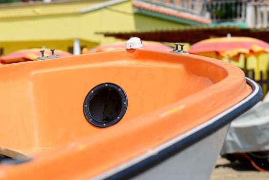 nice orange boat with a black hole