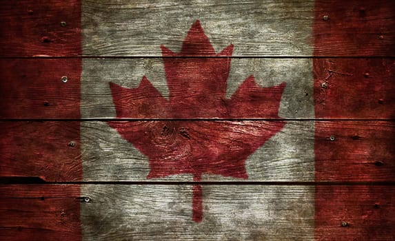 flag of canada on old wooden boards