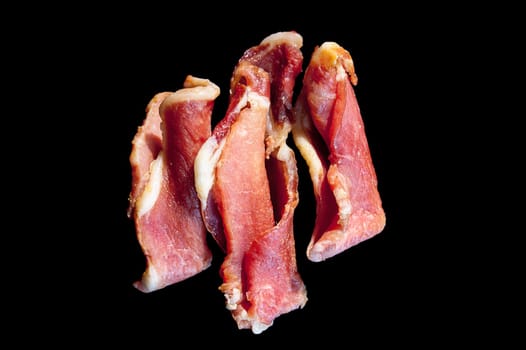Piggy jerky isolated on black. Three in a row.