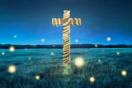 Cross with christmas lights decoration on the field at night
