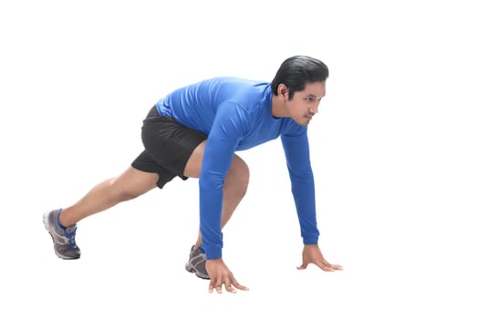 Portrait of asian sportsman in ready position to run isolated over white background
