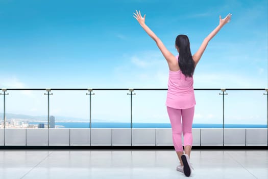 Beautiful asian woman enjoying exercise on terrace gym