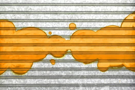 Orange bubbles painted with spray paint on a roller shutter.