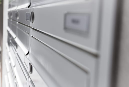 Rows of aluminum mail boxes for concepts such as safety and security, business communication and concepts. Shallow depth of field.