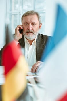 The business man working at table. The meeting or summit concept