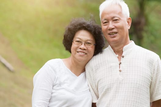 Happy old Asian seniors couple at outdoor park.