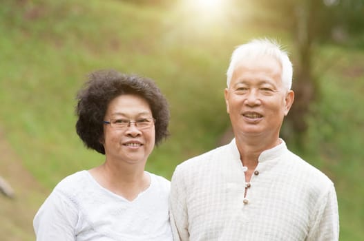Happy mature Asian seniors couple at outdoor park.